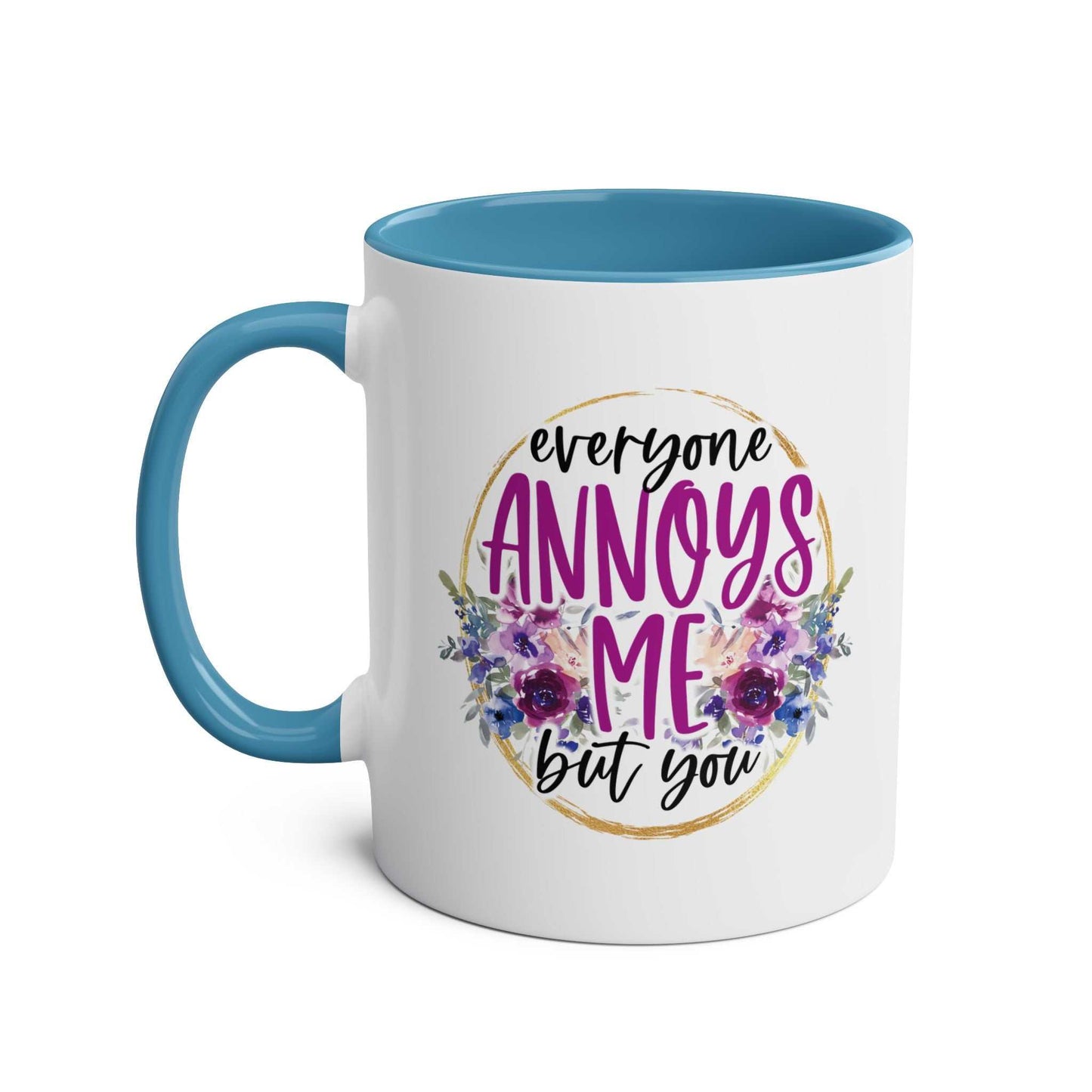 Everyone Annoys Me But You coffee mug with floral design, blue handle.