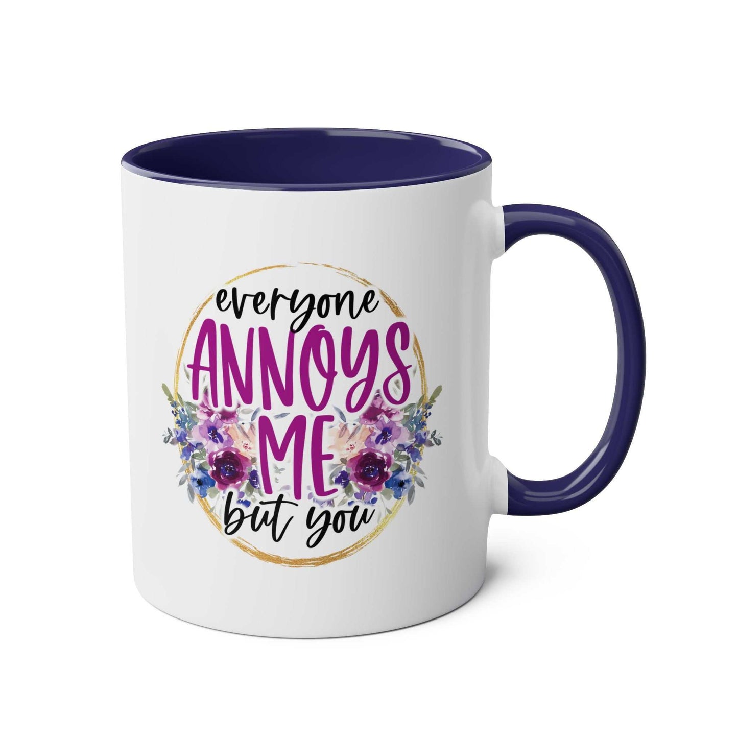 Everyone Annoys Me But You coffee mug with floral design and dark handle.