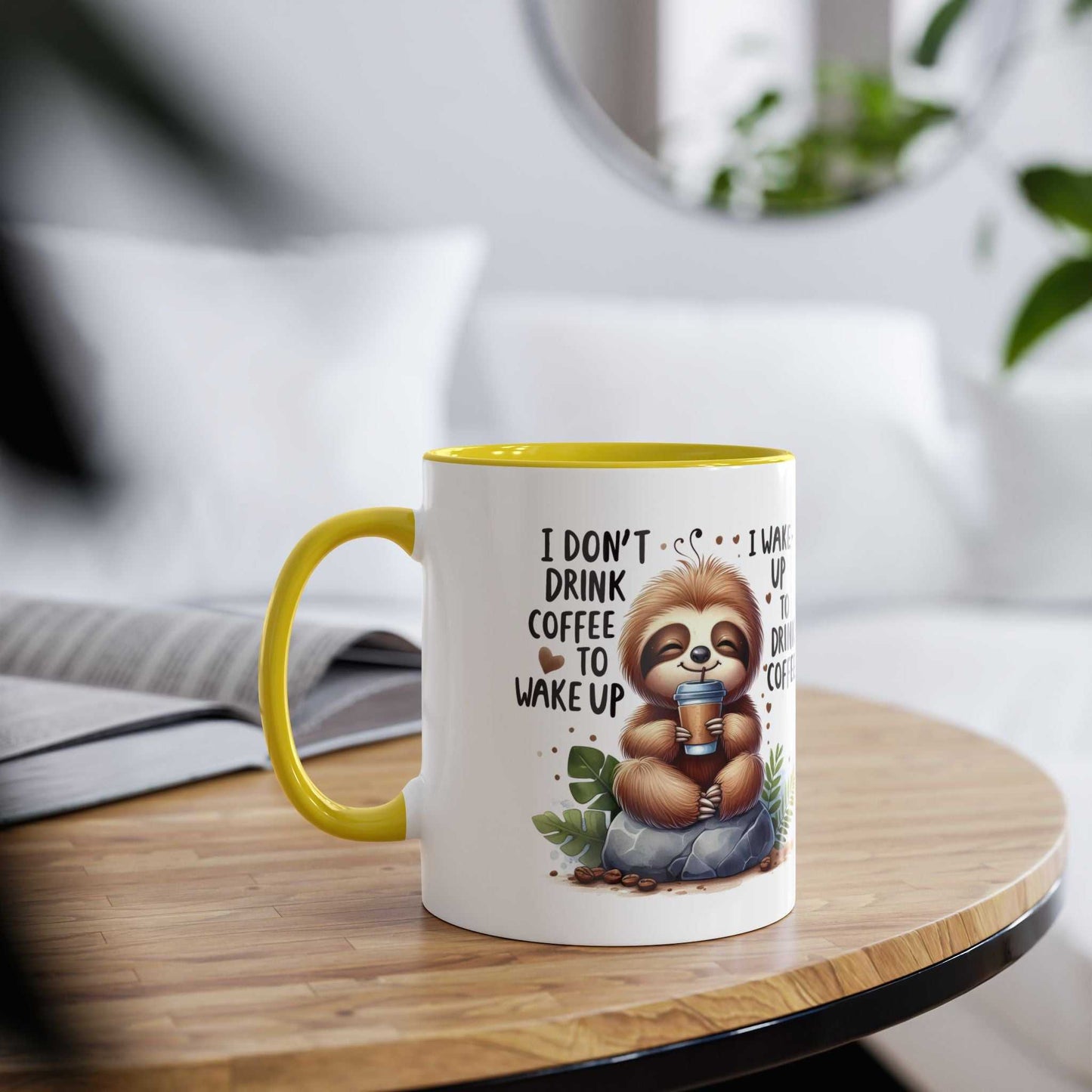 Cute sloth coffee mug with whimsical print and yellow handle on a wooden table.