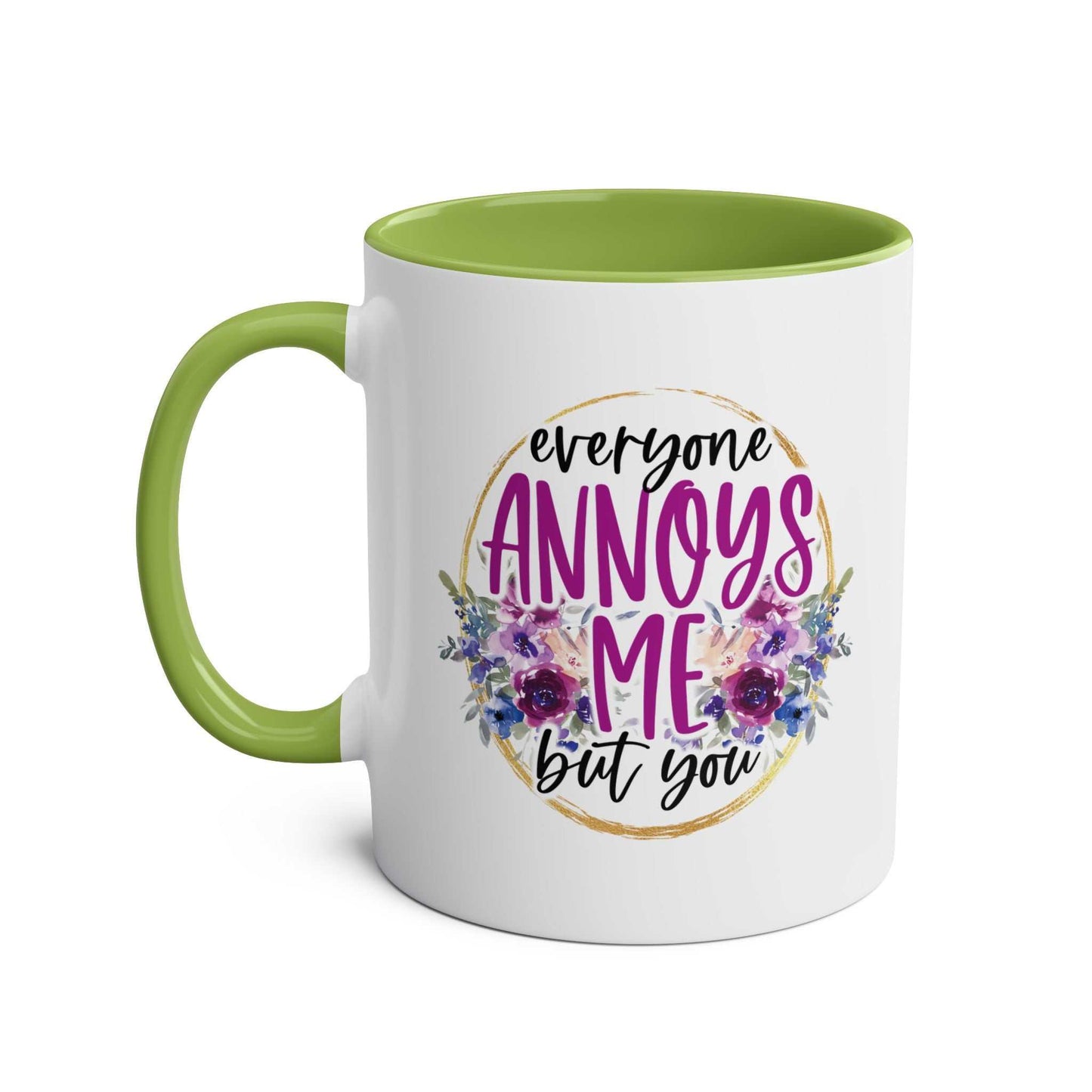 Everyone Annoys Me But You coffee mug with floral design and green handle.