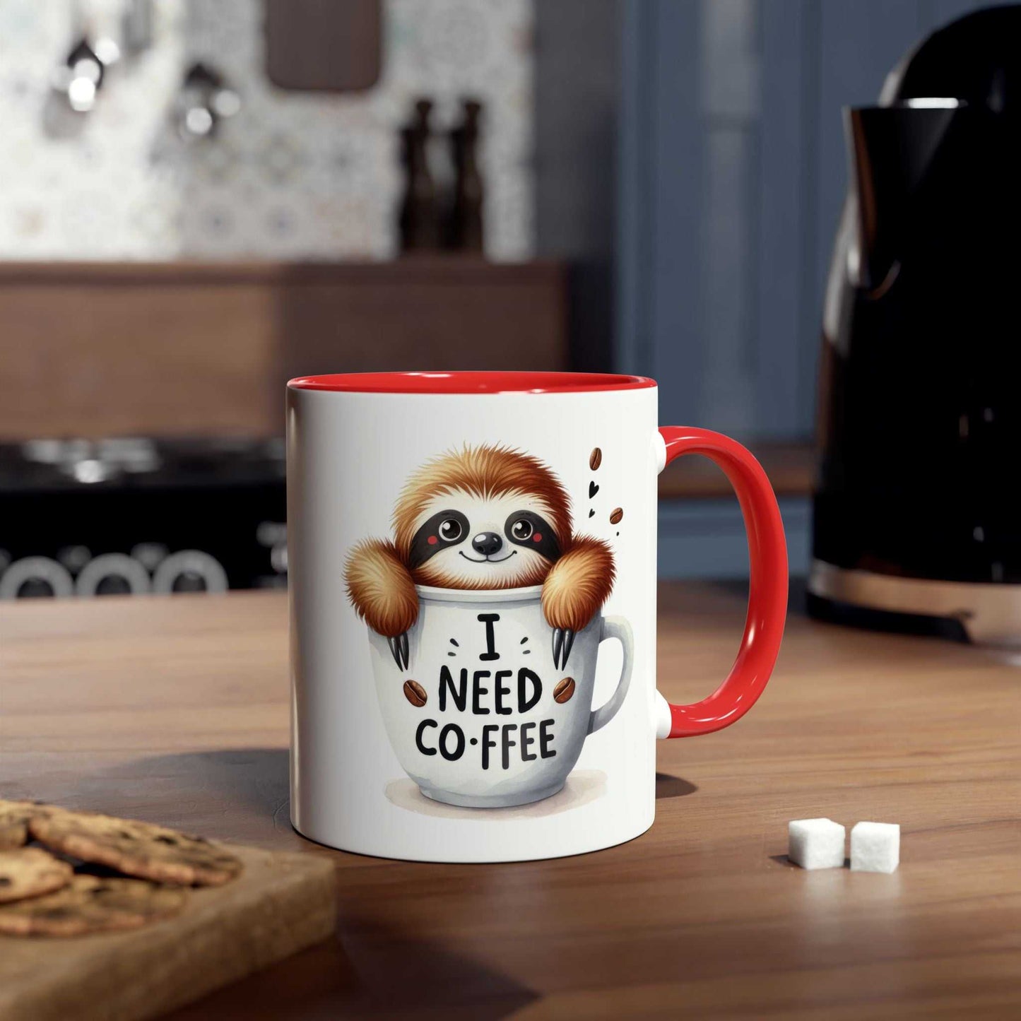 Cute sloth coffee mug on kitchen counter with text "I Need Coffee", red handle, whimsical design.