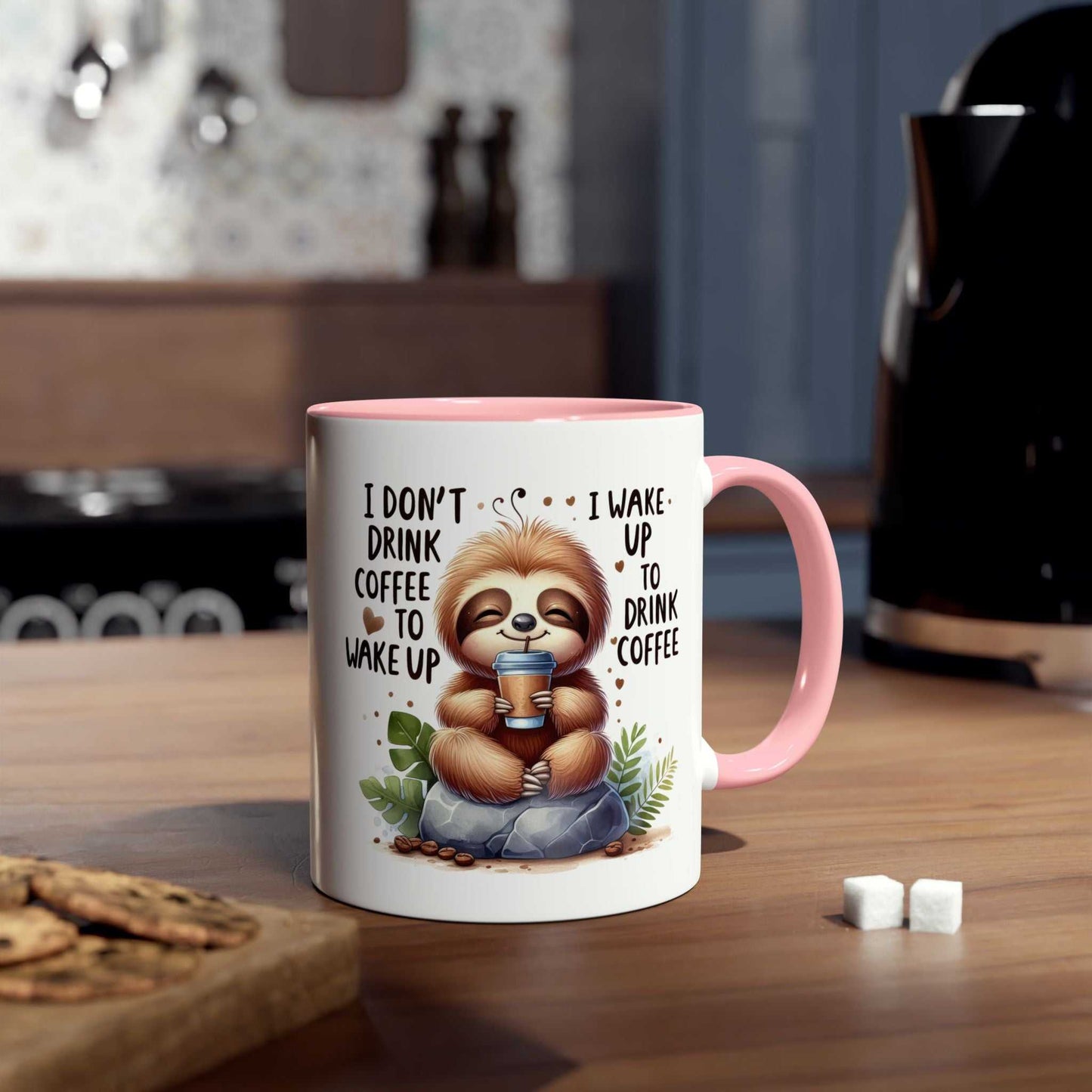 Cute sloth coffee mug with a whimsical design and pink handle in kitchen setting.