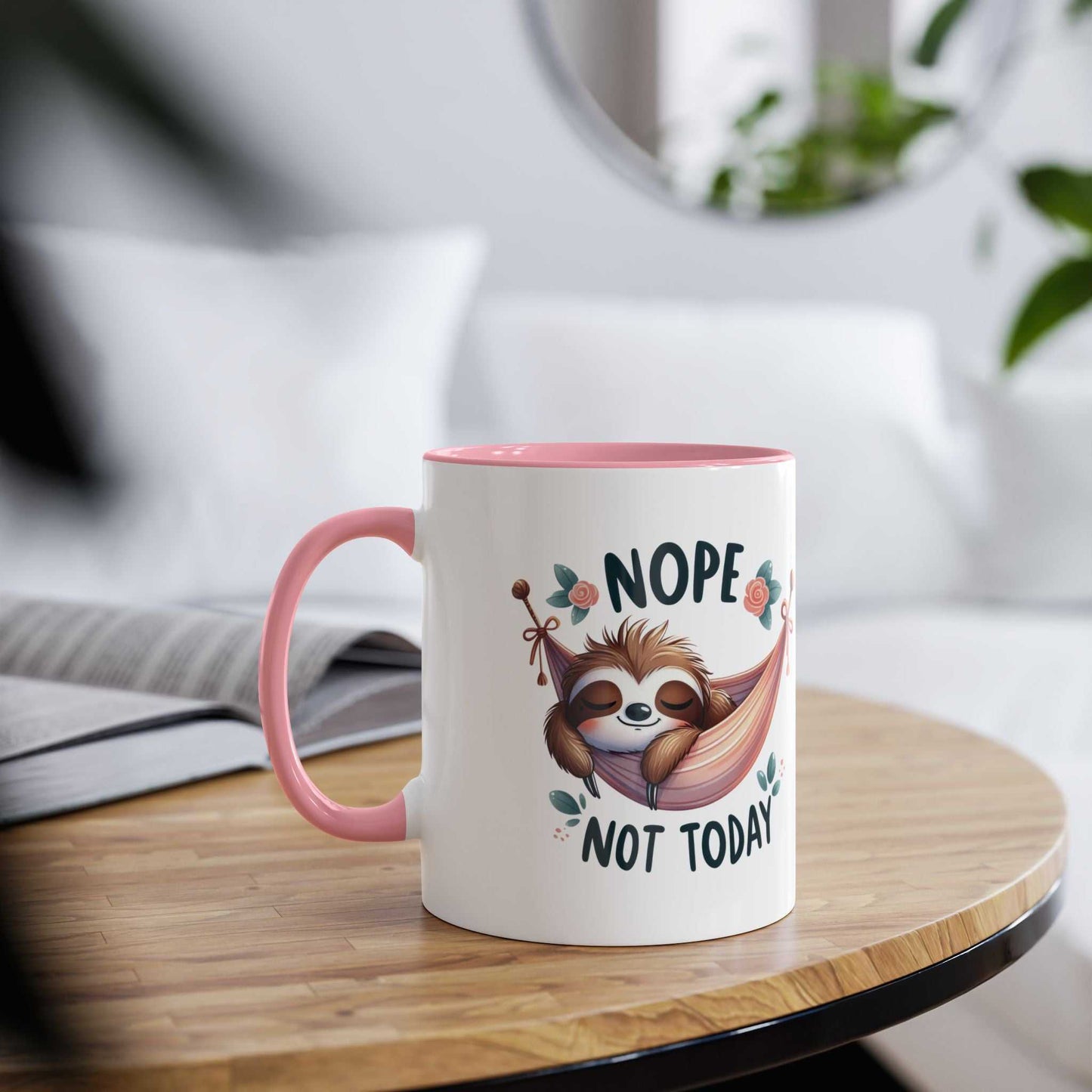 Cute sloth coffee mug with playful design on wooden table, pink interior and handle.