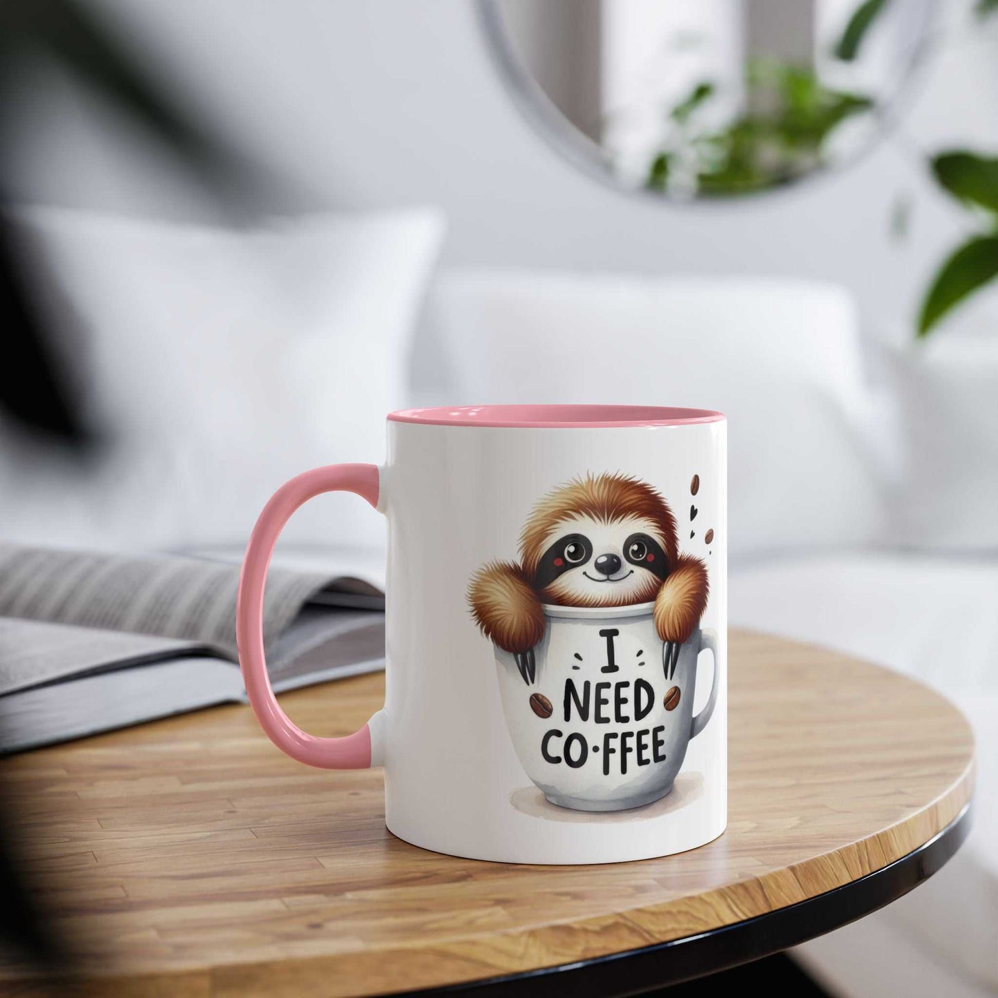 cute sloth coffee mug with pink handle and funny "I need coffee" design on wooden table