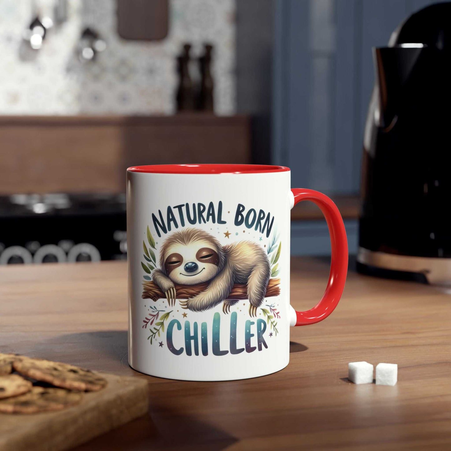 Cute sloth coffee mug with "Natural Born Chiller" design on kitchen counter.