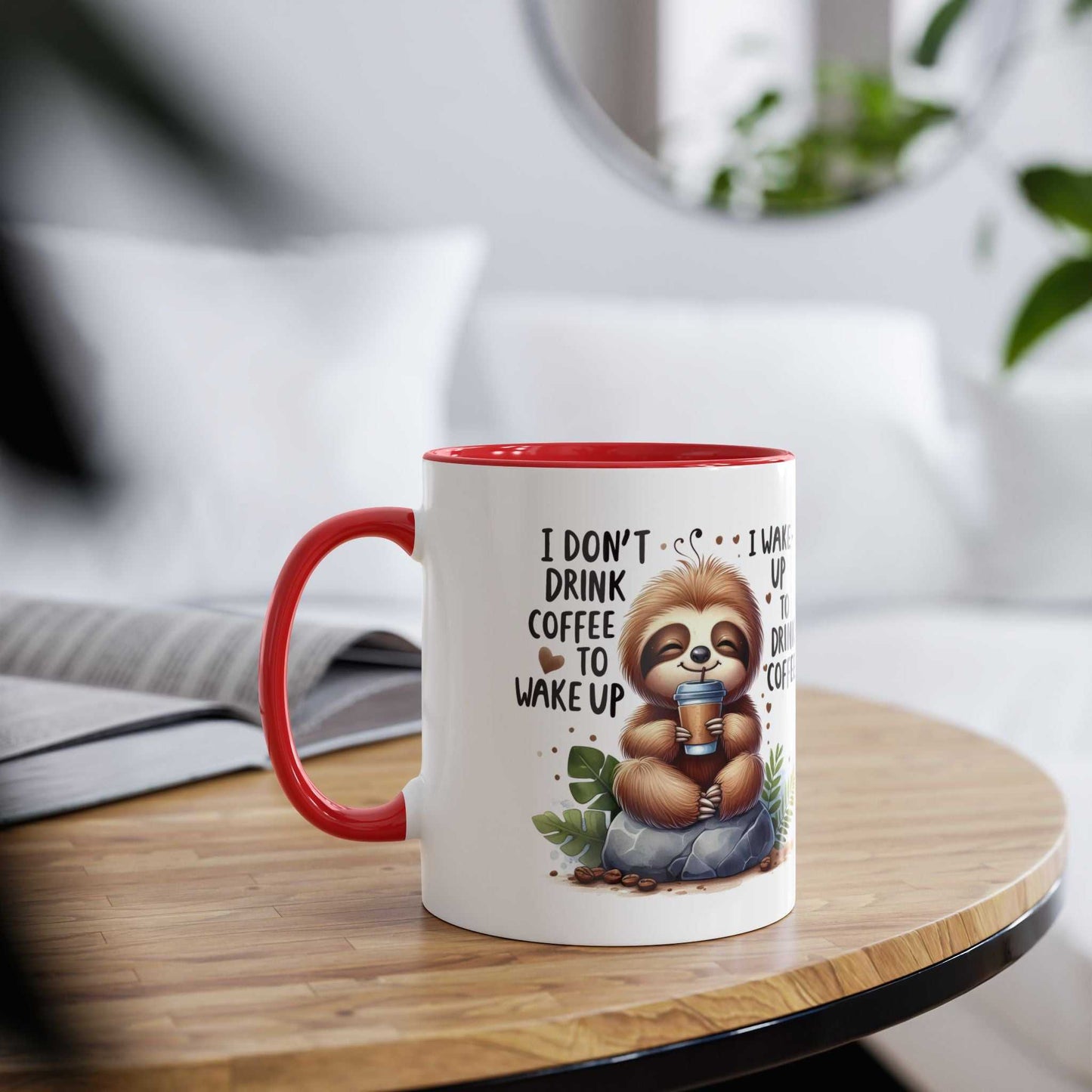 Cute sloth coffee mug with cheerful design and red handle on a wooden table.
