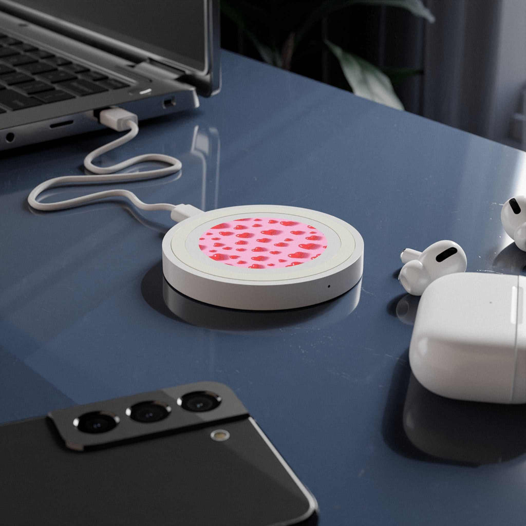 Pink Hearts Design wireless charging pad with 5W power and compact 7cm diameter on desk with smartphone and earbuds