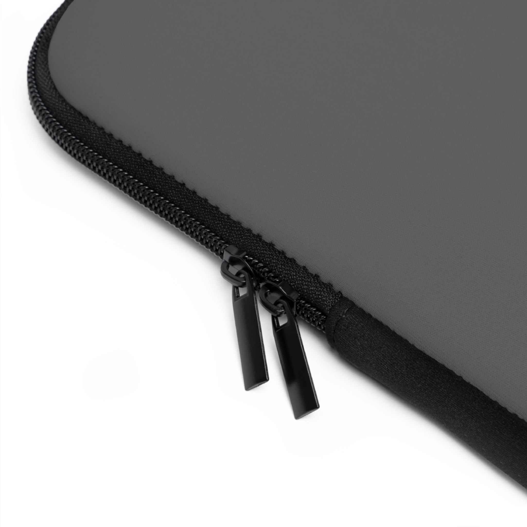Close-up of gunmetal grey neoprene laptop sleeve with dual black zipper and soft foam lining protection