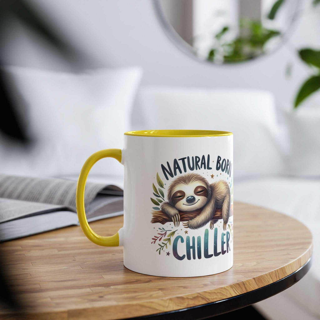 Cute sloth coffee mug with text "Natural Born Chiller" on a table.