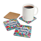 Colorful "Welcome To The Fuckery" coaster set with floral design and a mug placed on one coaster.