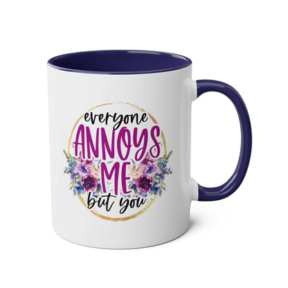 Everyone Annoys Me But You coffee mug with floral design and dark handle.