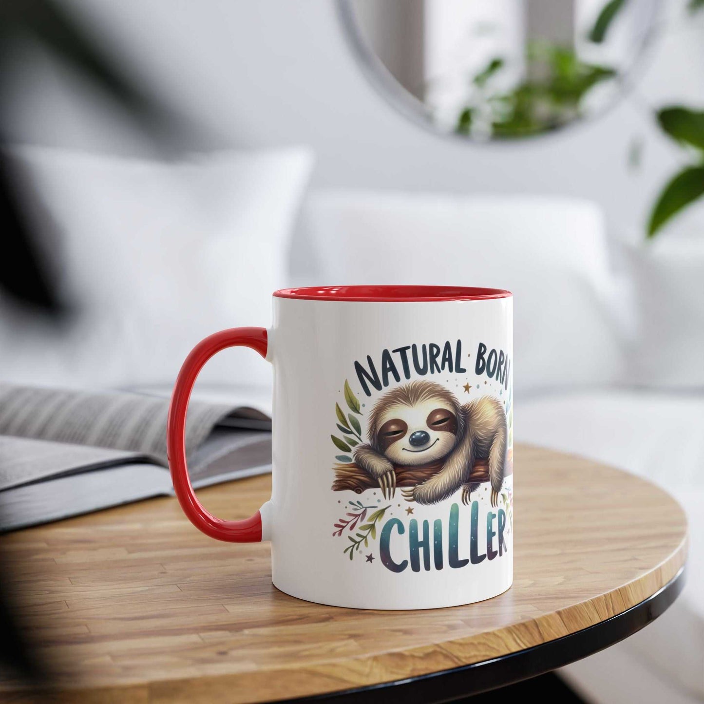 Cute sloth coffee mug with "Natural Born Chiller" design, red handle, on a wooden table. Ideal gift for animal lovers.