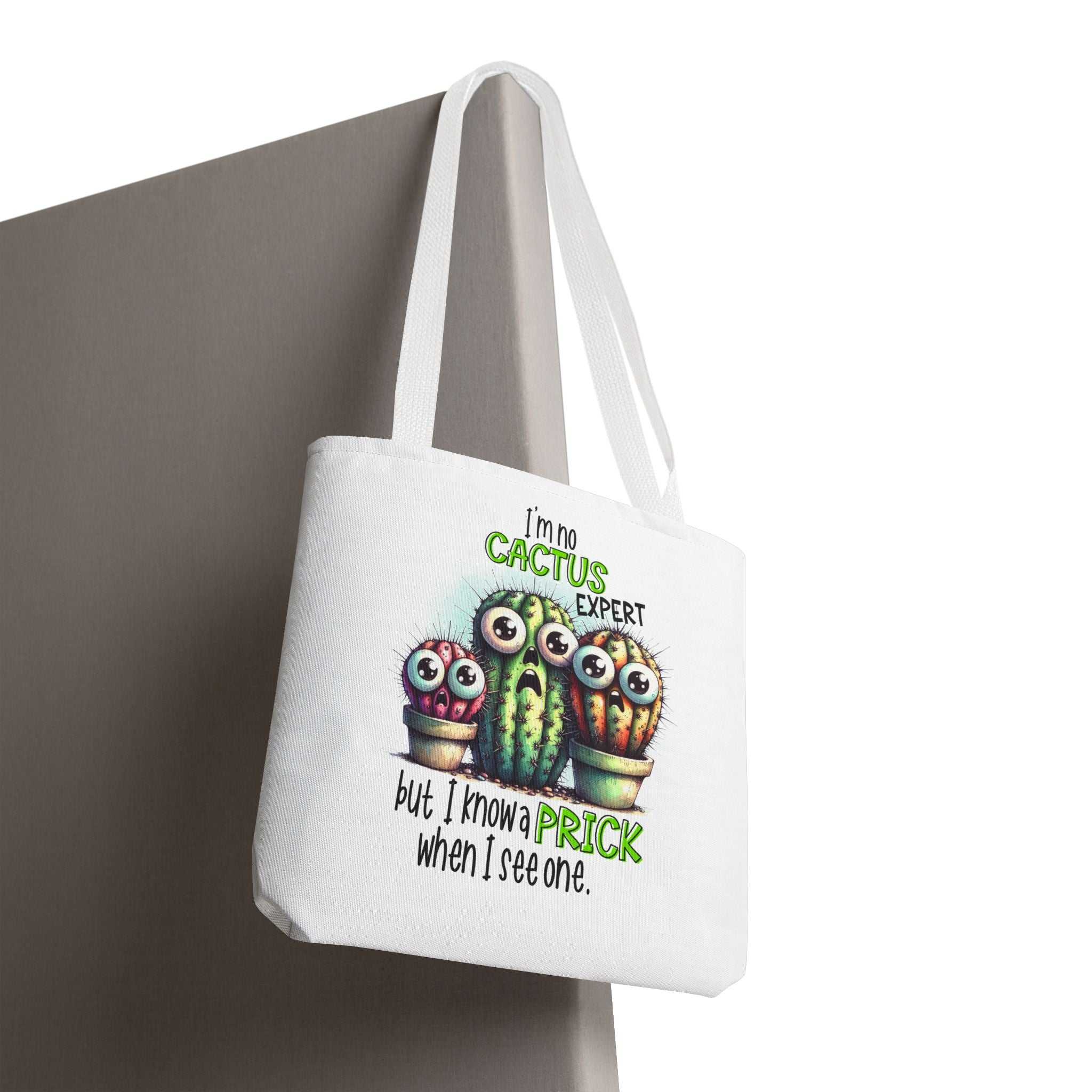 Fun cactus tote bag with cheeky printed design and colorful handles, made from durable spun polyester