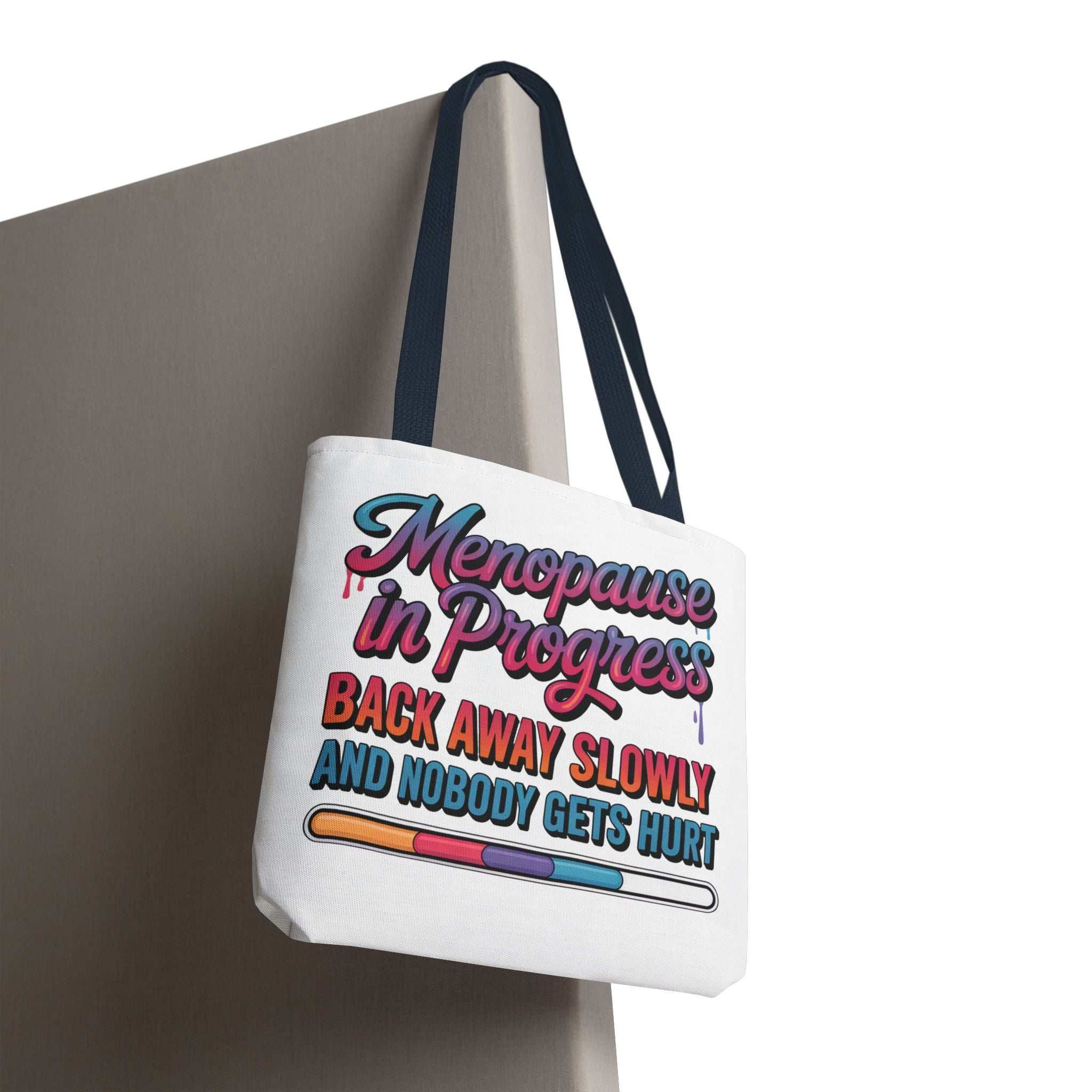 Menopause in Progress tote bag with cheeky design, durable spun polyester, three sizes, and multiple handle colors