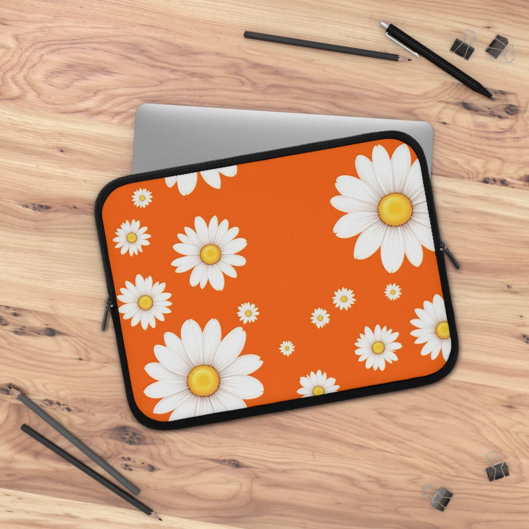 Orange laptop sleeve with white daisy pattern, neoprene protective cover for laptops, lightweight and waterproof with dual zipper closure