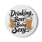 Round ceramic coaster with "Drinking Beer & Being Sexy" text and beer illustrations, cork backing, protective and non-slip surface