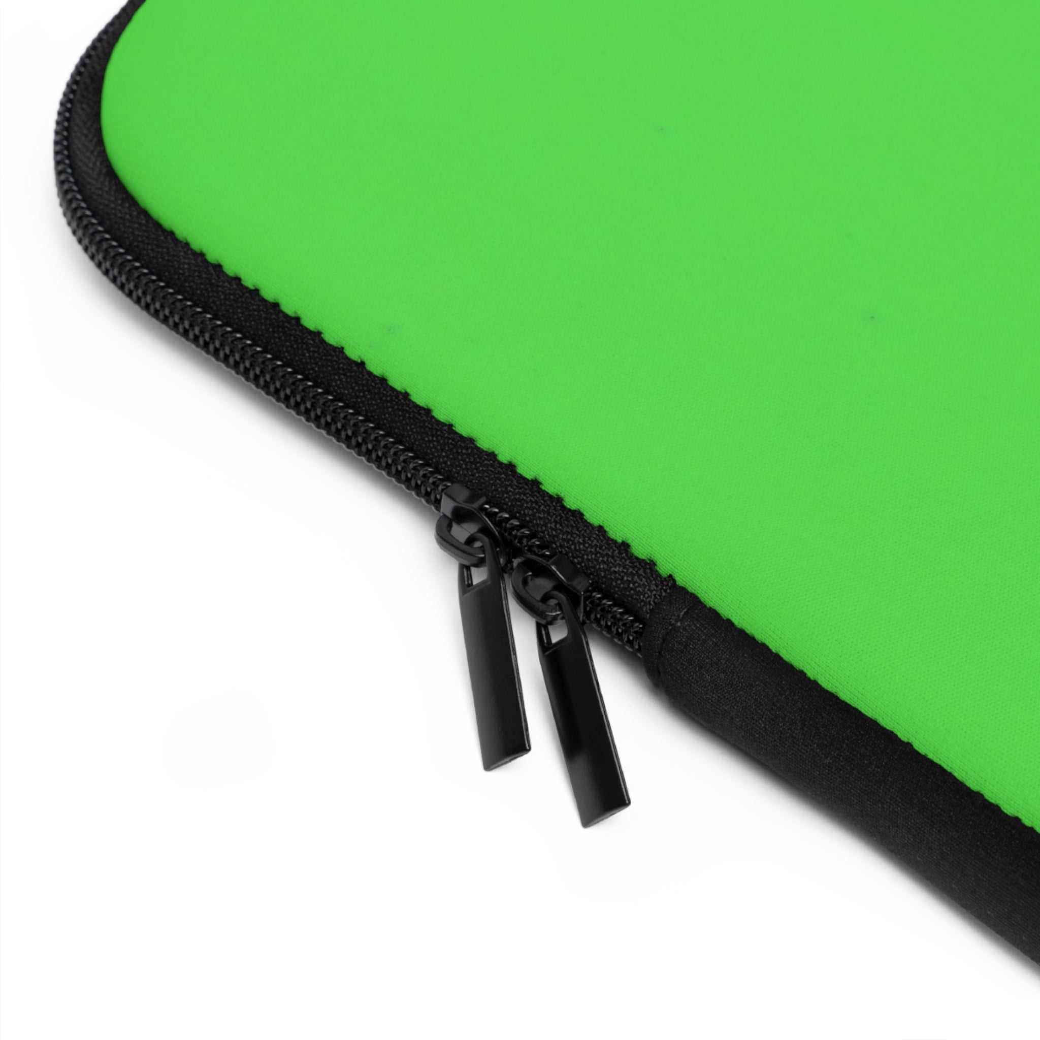 Close-up of lime green laptop sleeve with black dual zipper and neoprene material