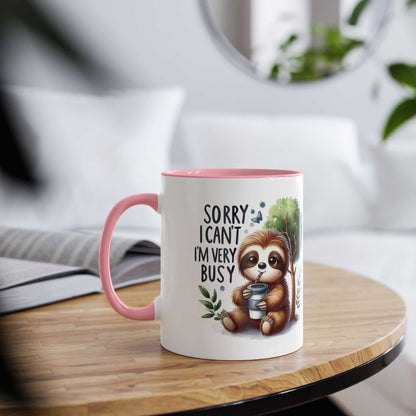 Cute sloth coffee mug with whimsical design on a cozy table setting.