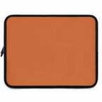 Bold orange laptop sleeve with black trim, durable neoprene, soft foam lining, dual zipper, lightweight and waterproof protection.