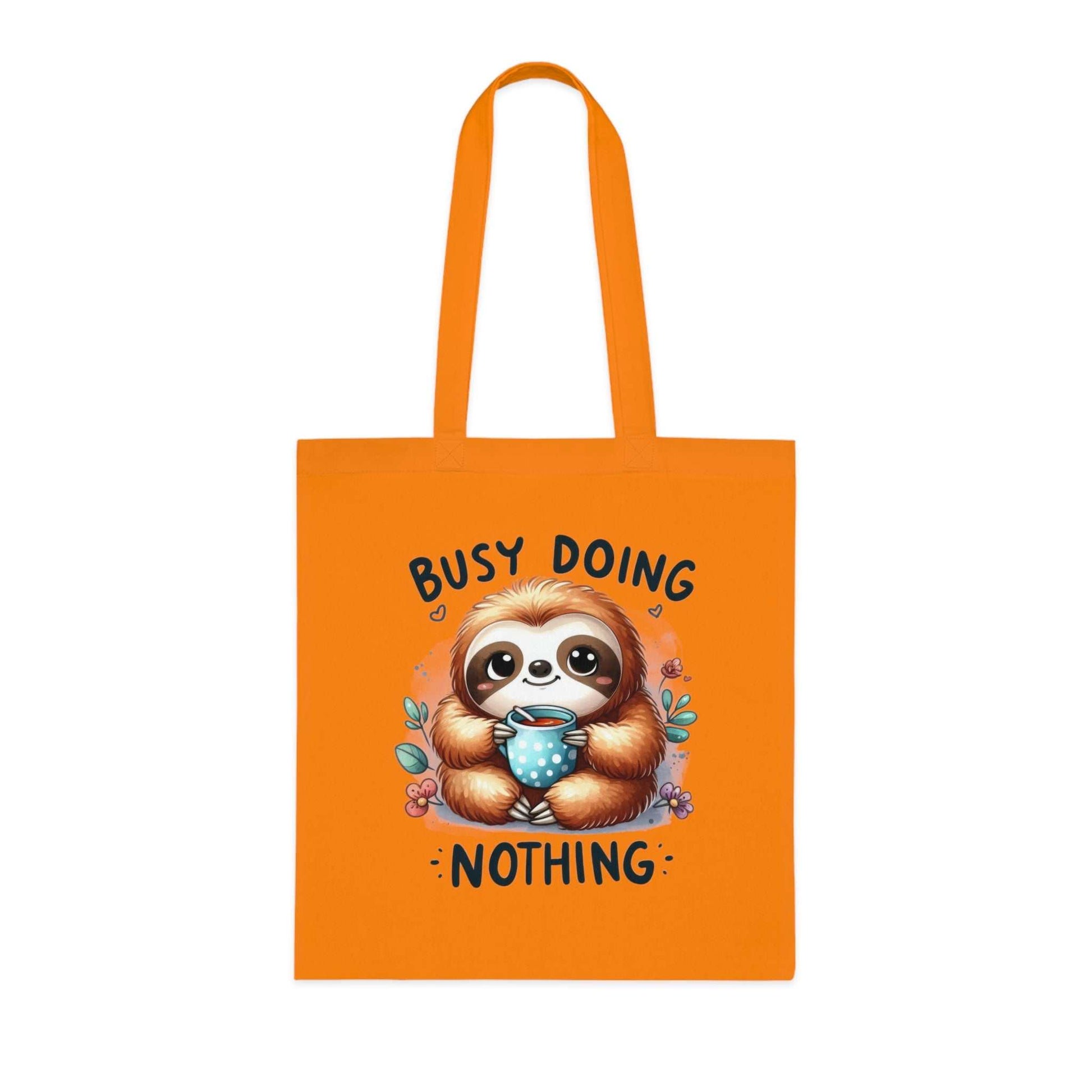 Cute sloth tote bag in orange with "Busy Doing Nothing" text, 100% cotton.