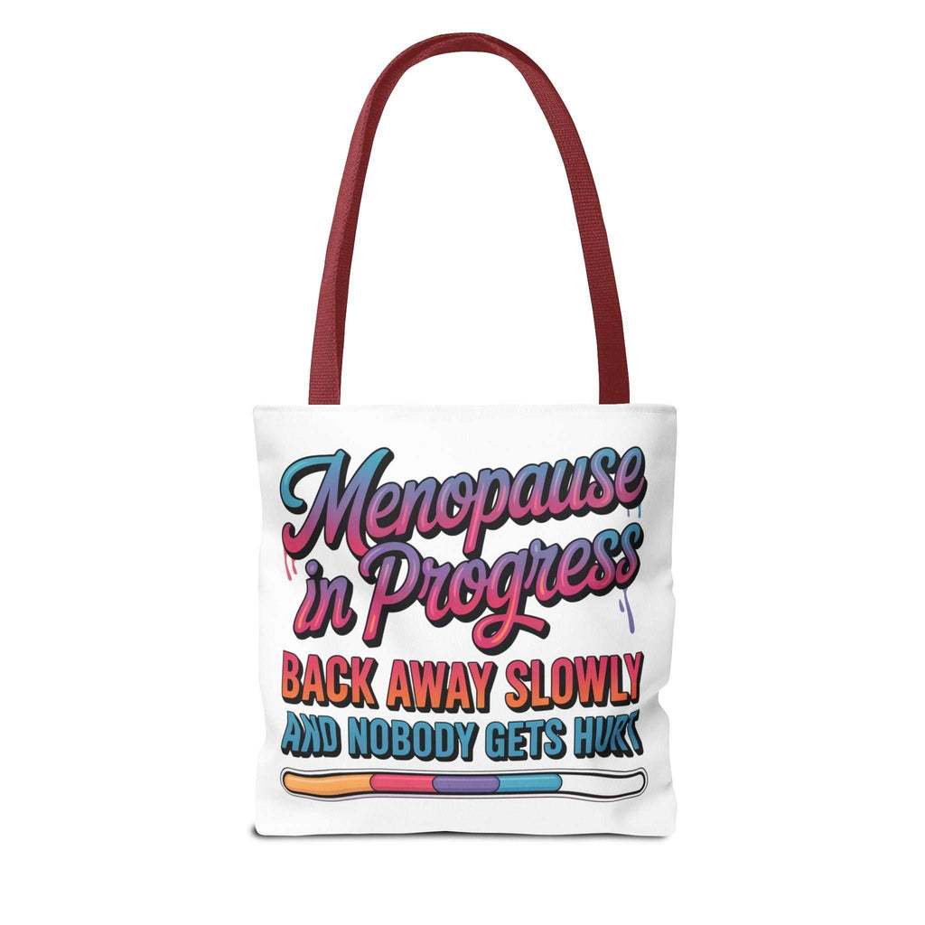 Menopause in Progress tote bag with cheeky design and multiple handle color options, durable spun polyester, available in three sizes
