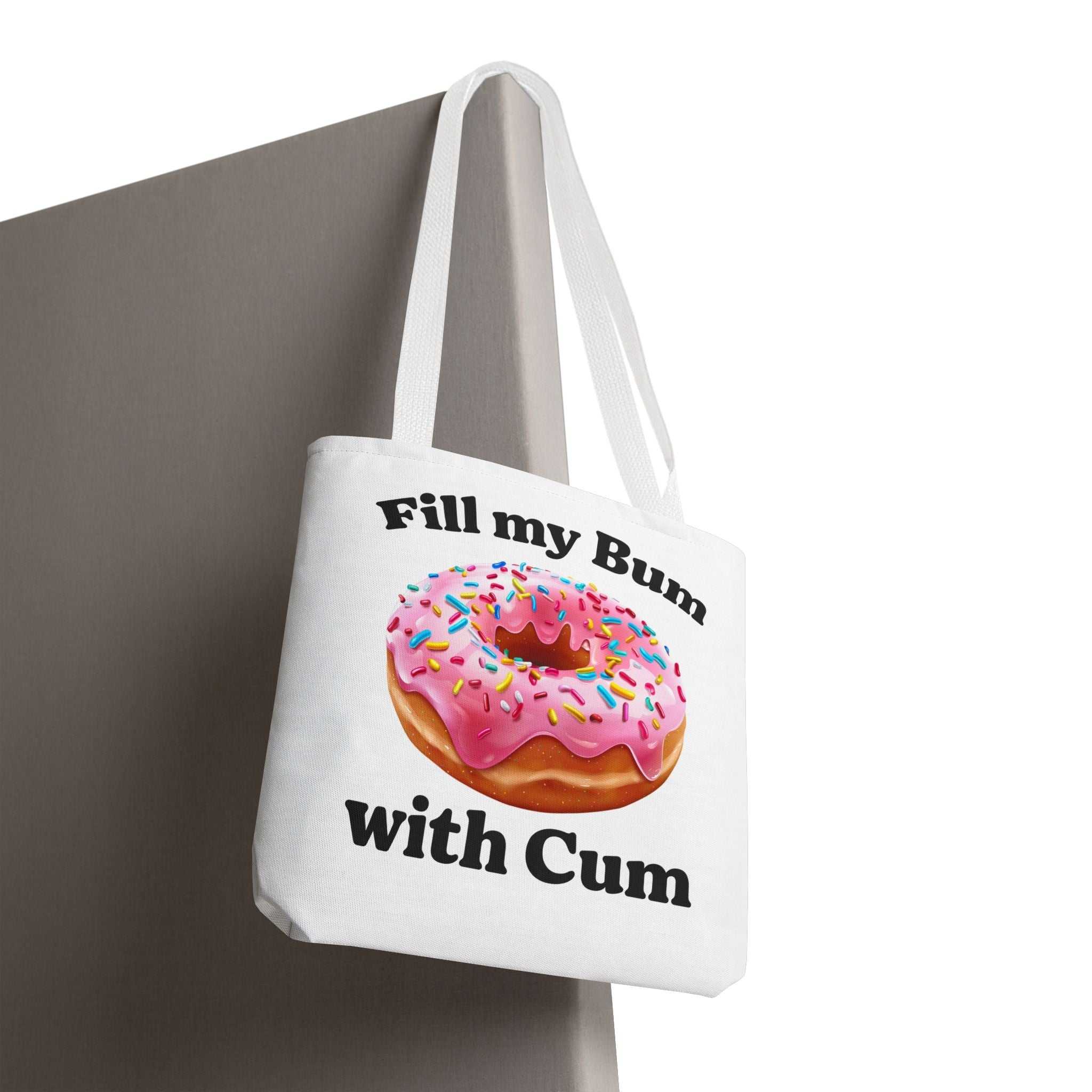 Provocative donut tote bag with cheeky design, durable spun polyester, multiple sizes and handle colors, perfect for errands and casual outings