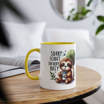 Cute sloth coffee mug with whimsical design and yellow interior on table.