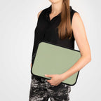 Sleek sage green laptop sleeve made of durable neoprene with soft foam lining and dual zipper, lightweight and waterproof for travel or work protection