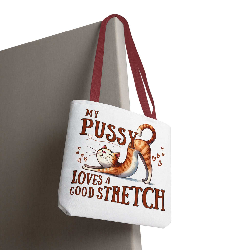 Fun stretching cat tote bag with cheeky printed design and colorful handles