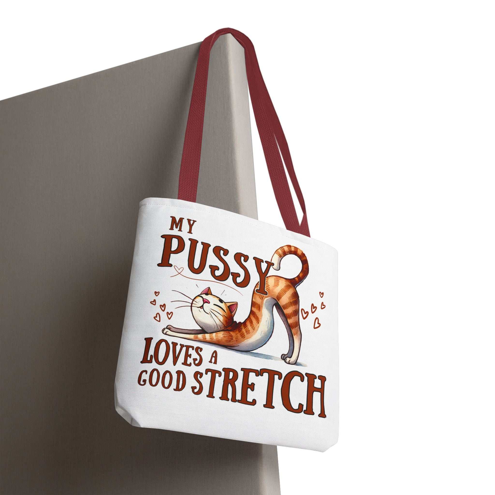 Fun stretching cat tote bag with cheeky printed design and colorful handles