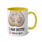 White ceramic "I Am Nuts About You" mug with yellow handle and rim, featuring a playful cartoon design and cheeky text