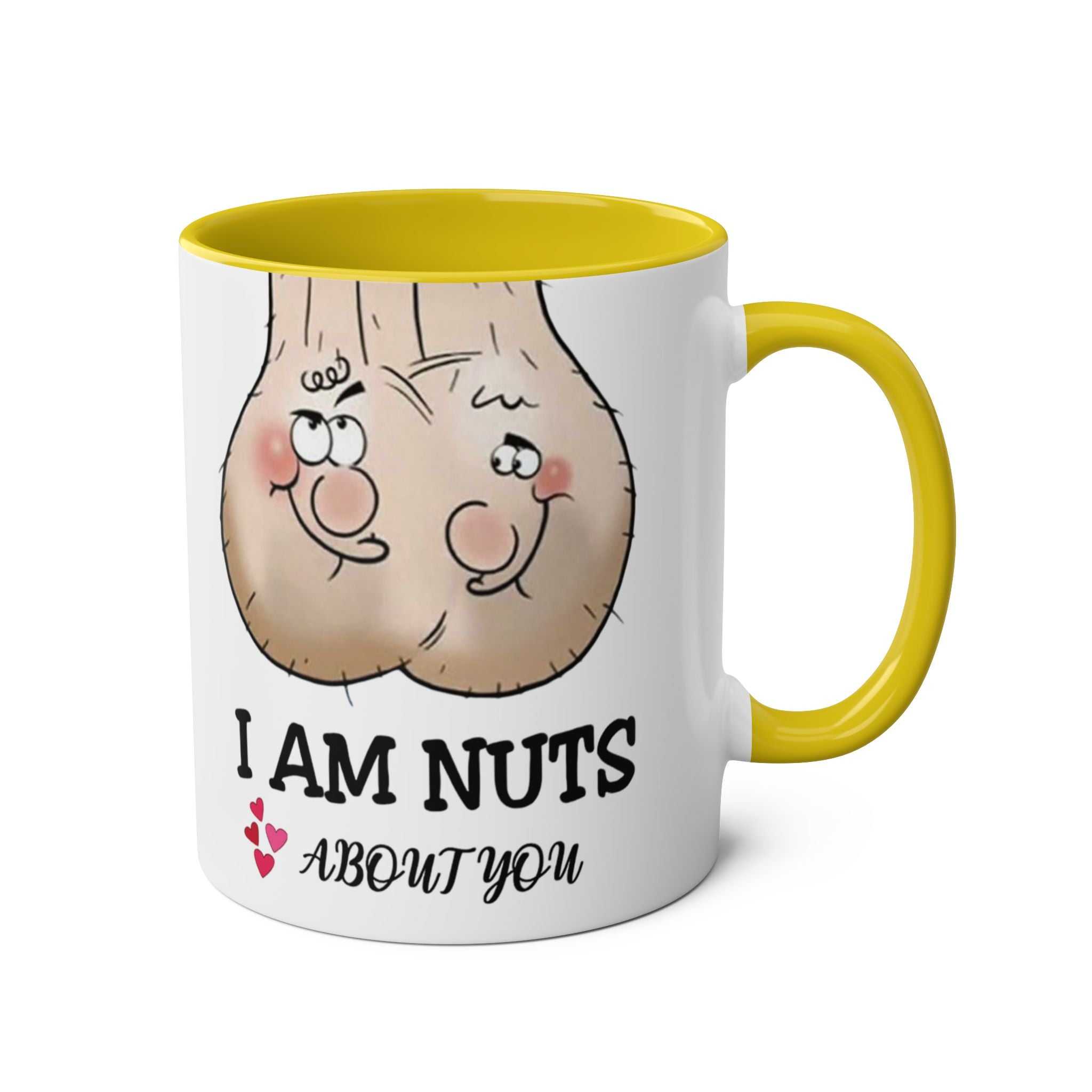 White ceramic "I Am Nuts About You" mug with yellow handle and rim, featuring a playful cartoon design and cheeky text