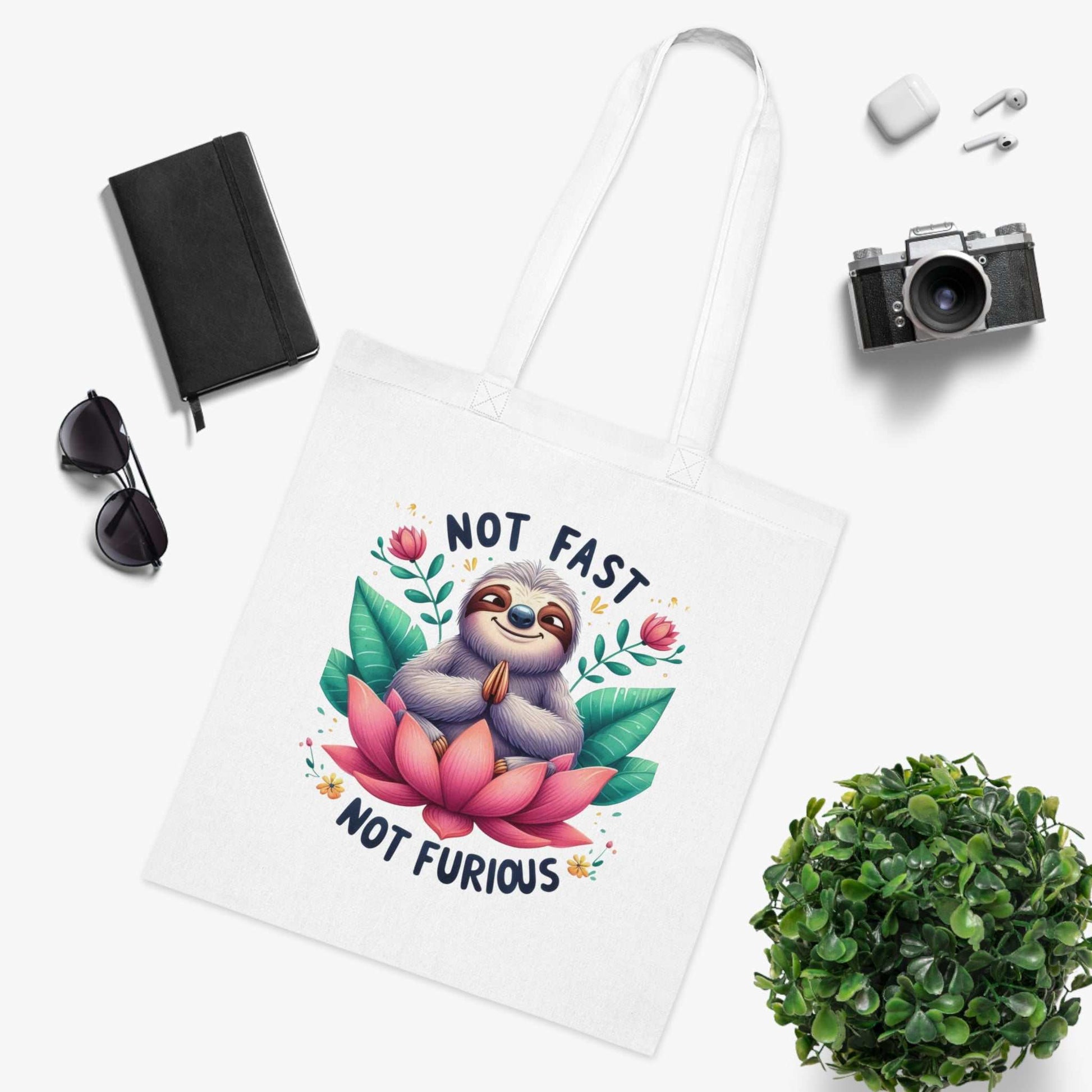 Cute sloth cotton tote bag with vibrant colors and playful design, perfect for carrying essentials.