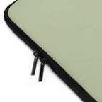 Sage green neoprene laptop sleeve with black dual zipper and soft foam lining for protection