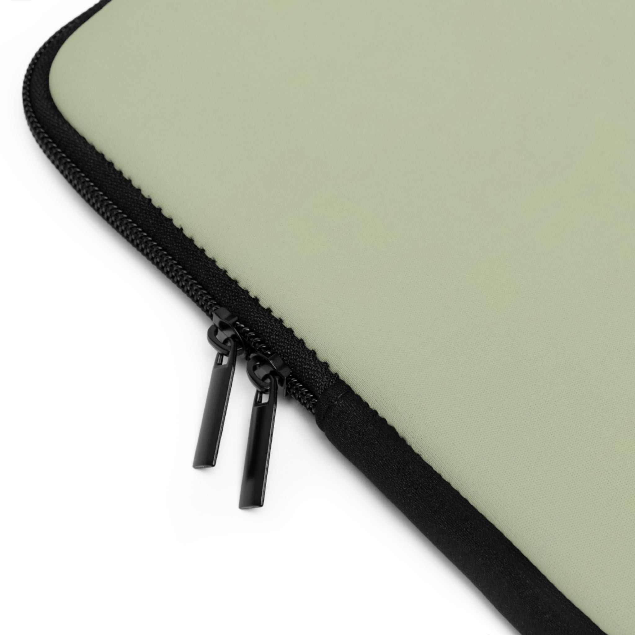 Sage green neoprene laptop sleeve with black dual zipper and soft foam lining for protection