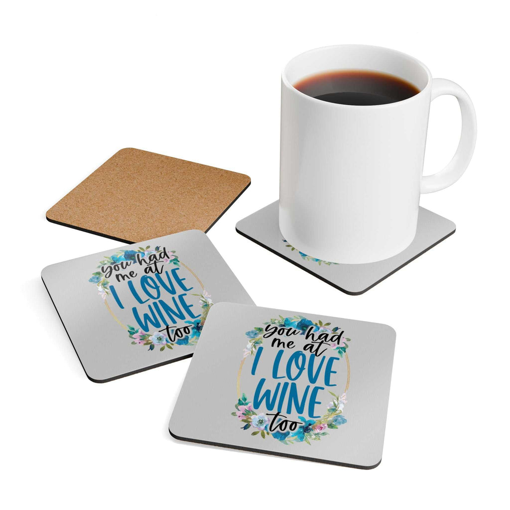 Love Wine Coaster Set with playful design, cork back, and heat-resistant feature on a coffee table.