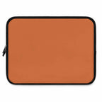 Bold orange laptop sleeve made of durable neoprene with soft foam lining and dual zipper closure.