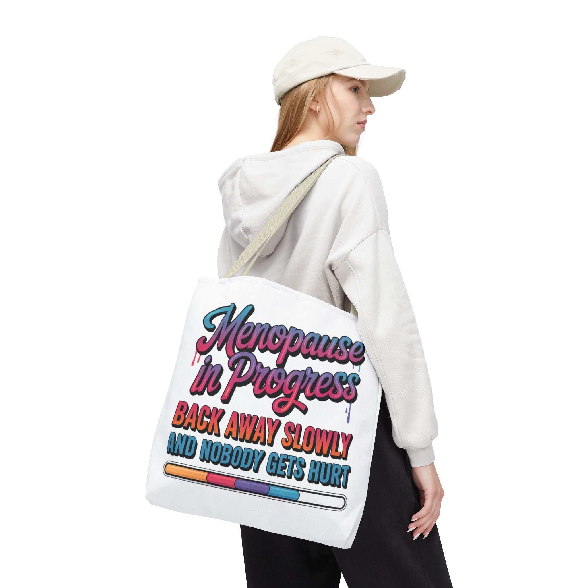 Menopause in Progress tote bag with cheeky design, durable spun polyester, multiple sizes and handle colors, reusable and lightweight for daily use