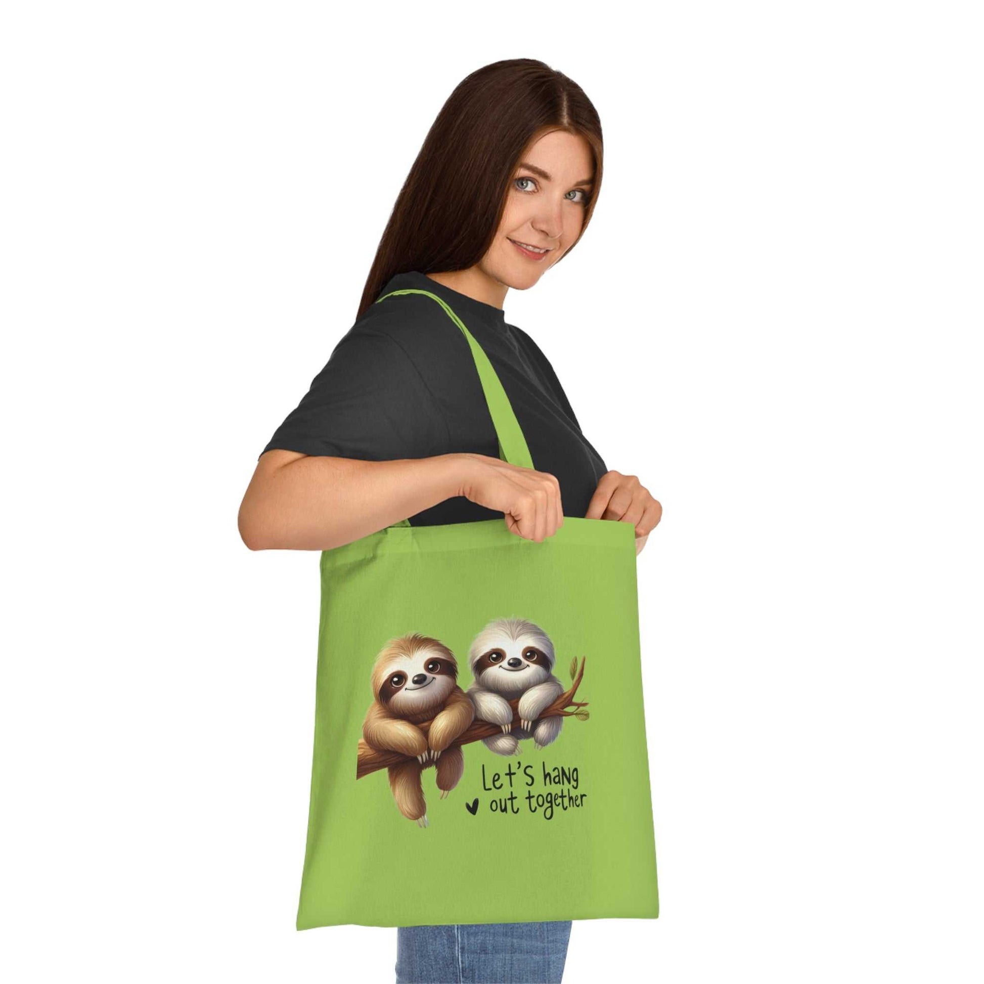 Cute green cotton tote bag with playful sloth design, ideal for sloth lovers and everyday use.