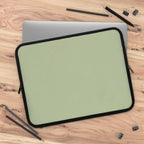 Sage green neoprene laptop sleeve with black trim, soft foam lining, dual zipper, lightweight and waterproof design for laptop protection.