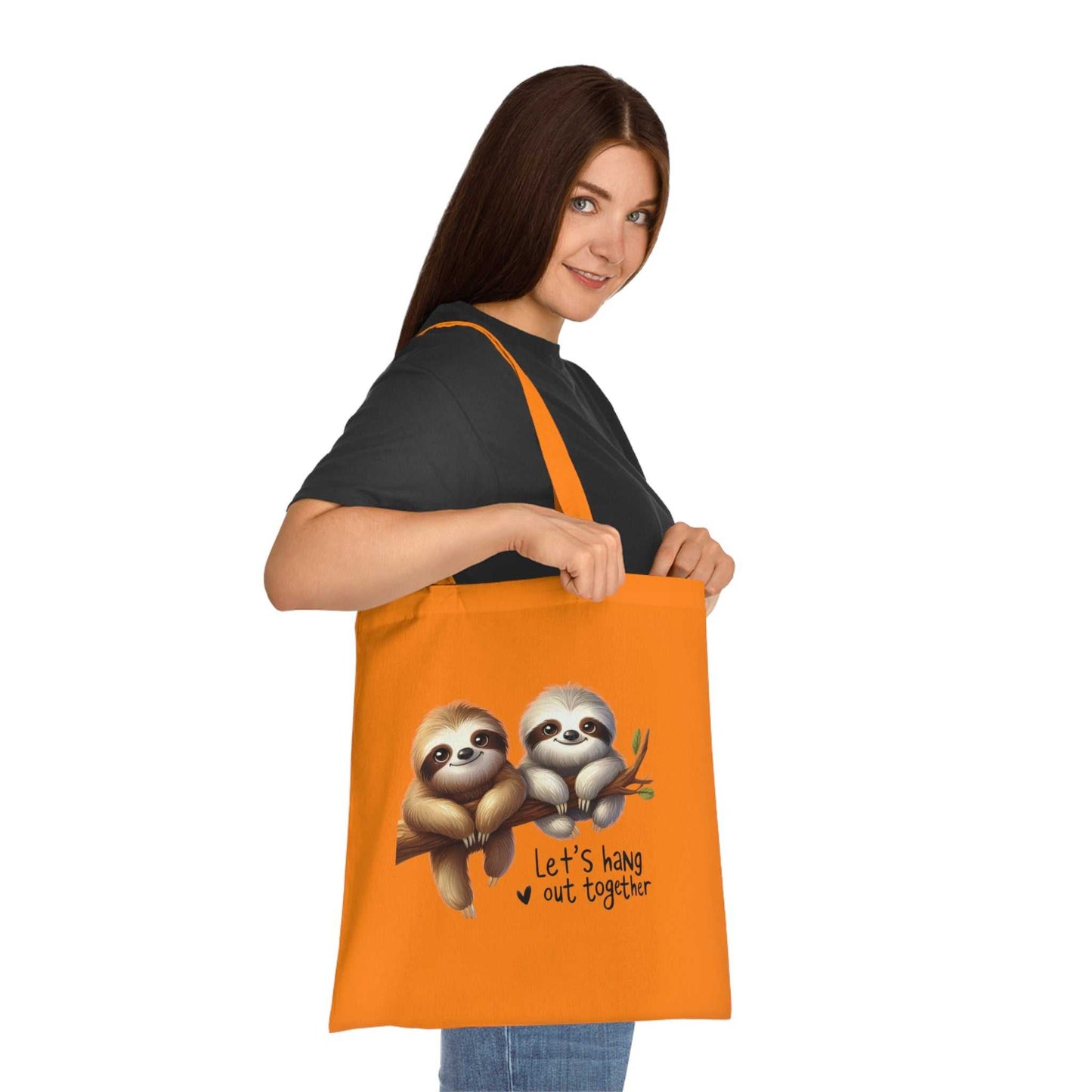 Cute sloth tote bag in orange cotton with playful design, perfect for carrying essentials.