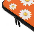 Close-up of orange daisy laptop sleeve with dual zipper and durable neoprene material