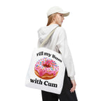 Provocative donut tote bag with cheeky print, durable spun polyester, available in three sizes and multiple handle colors.