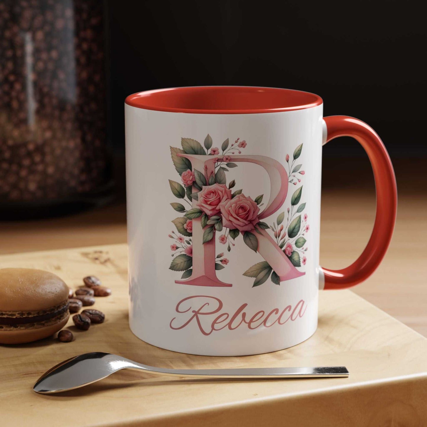 Personalised watercolour gift mug with name and floral design, red interior and handle, on wooden table setting.