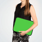 woman holding lime green neoprene laptop sleeve with black trim, lightweight and waterproof protective case