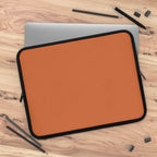 Bold orange neoprene laptop sleeve with black trim, dual zipper, and soft foam lining for protection.