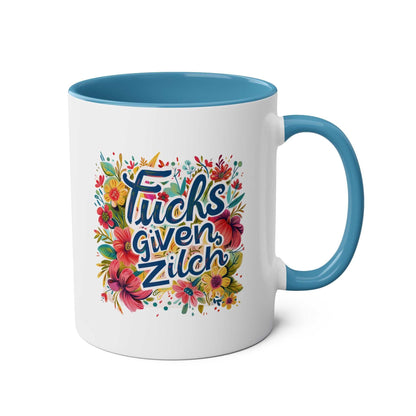 Zilch Coffee Mug with floral design, blue handle, and humorous text.