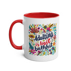 Colorful "Adulting Is Bullshit" coffee mug with cheeky floral design, 11oz ceramic, red handle.