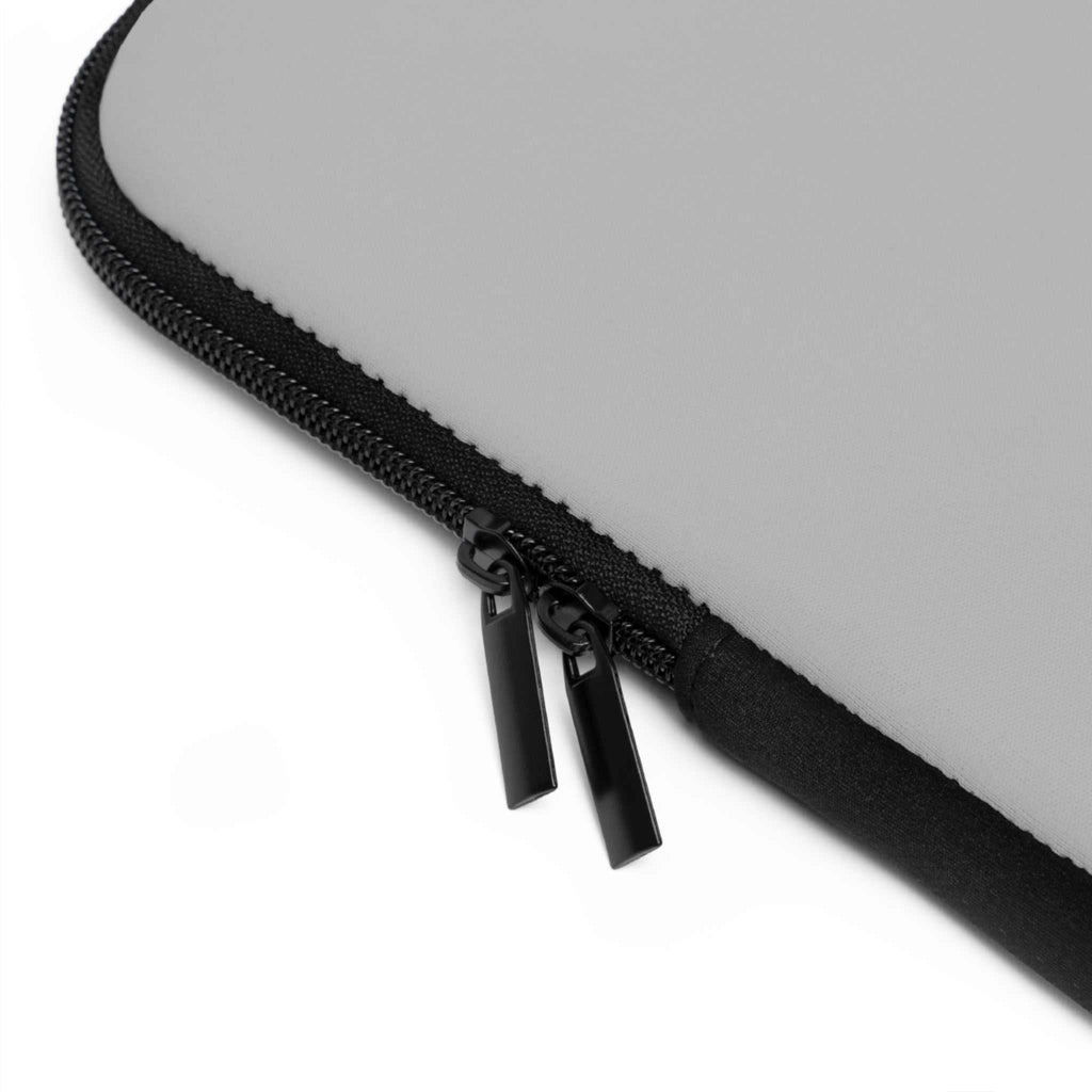 Close-up of silver neoprene laptop sleeve with dual black zipper and soft foam lining protection