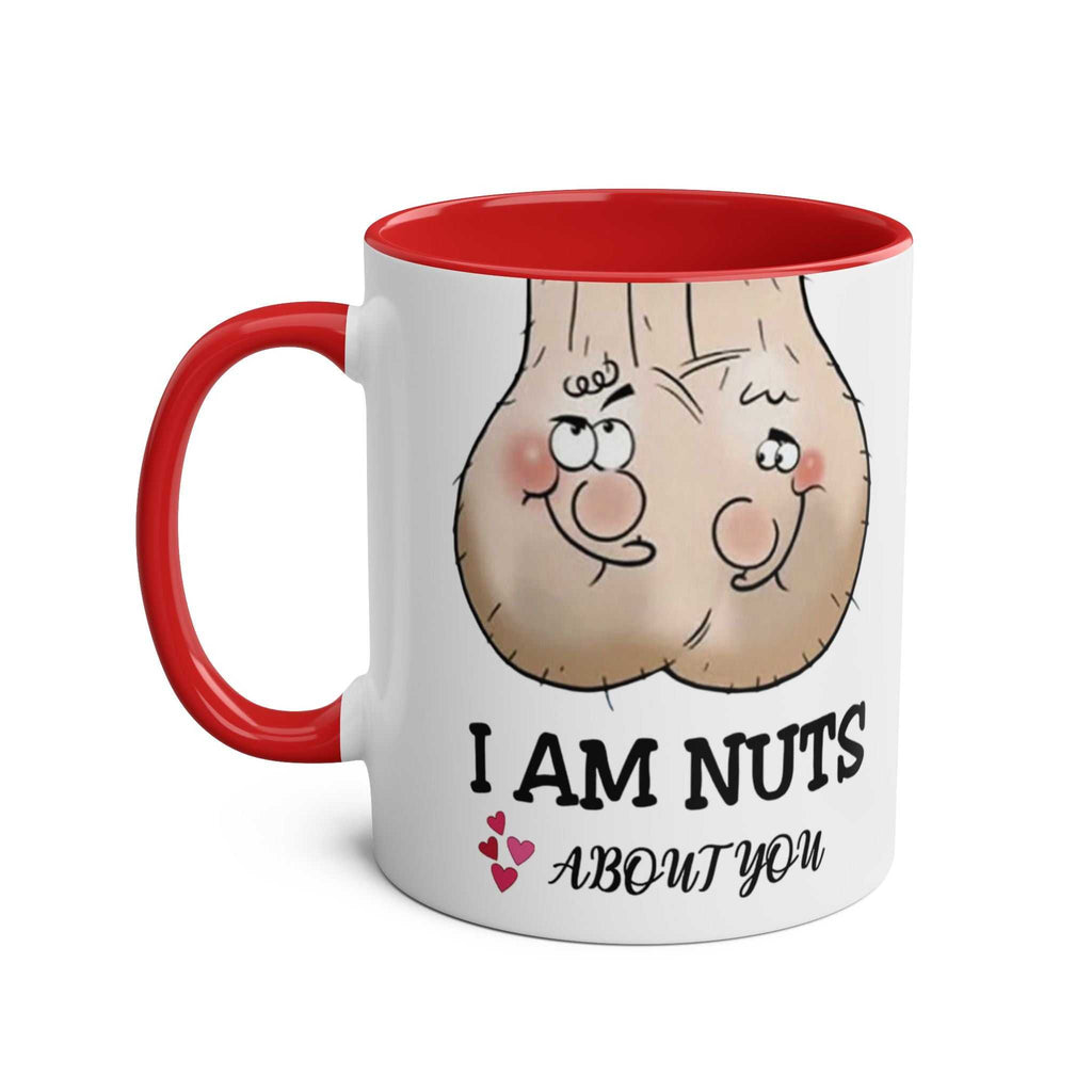White ceramic "Nuts About You" mug with red handle and interior, featuring cheeky cartoon nuts and playful text.